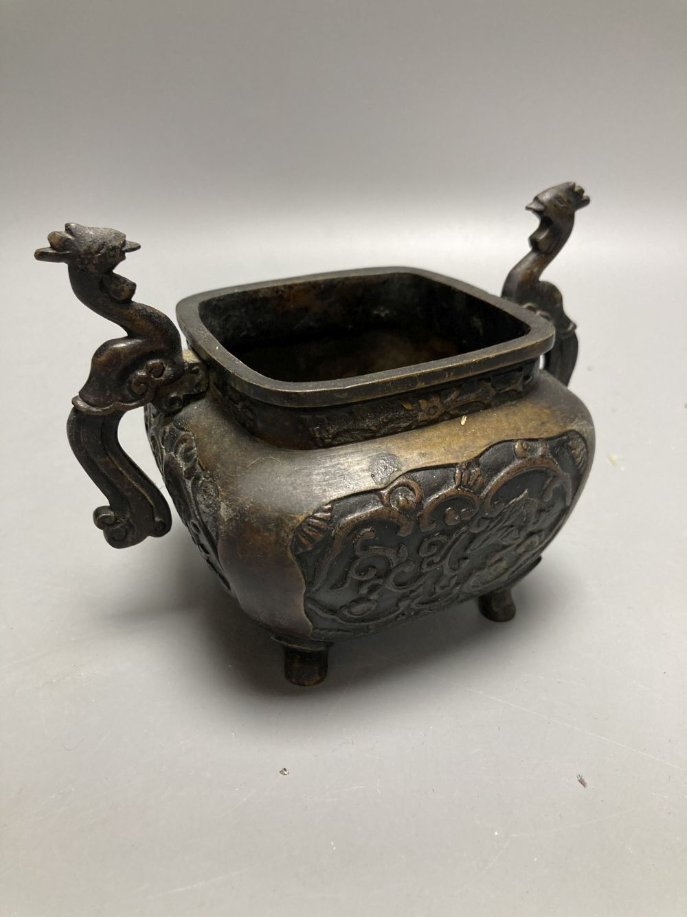 A Chinese bronze censor and a Buddhist figural stoop, stoop, 23cm high